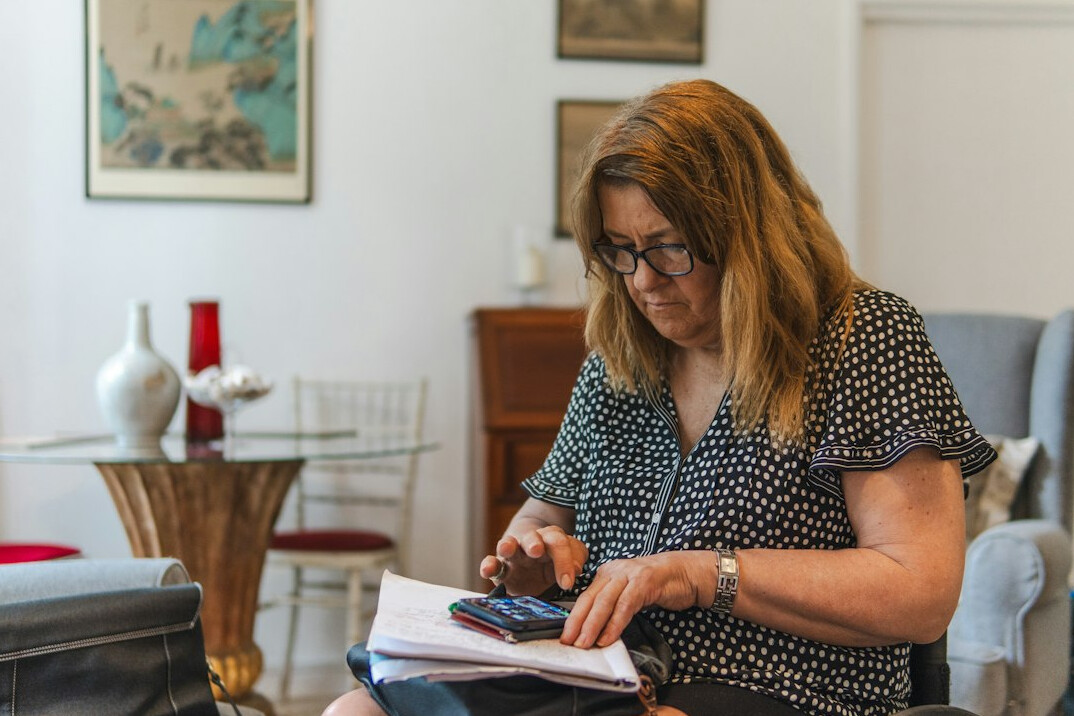 woman using calculator for bills