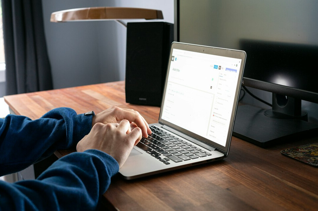 person checking finances on laptop